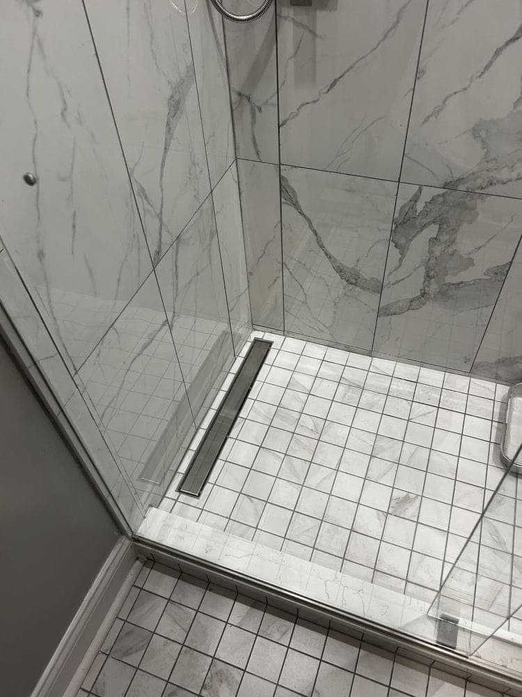 Walk-in shower with a linear drain